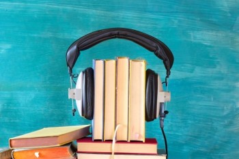 Large heap of books and heaphones, audio books concept, entertainment and education during corona lockdown